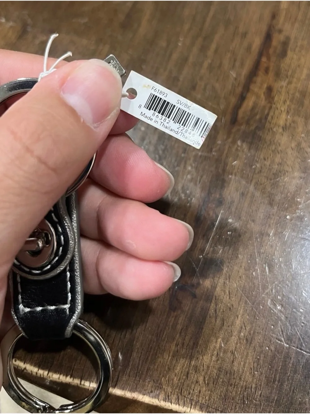Coach black leather valet keychain.